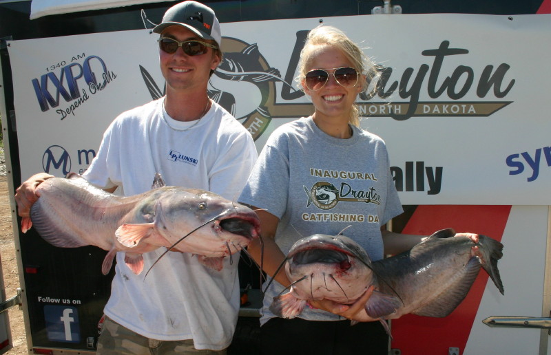 Picture of 2 guys holding catfish as tournament winners